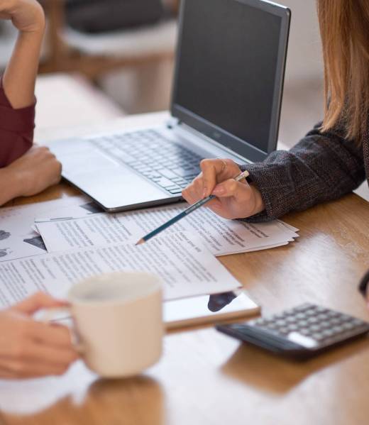group of women are discussing business strategies together. or students prepare for exams.